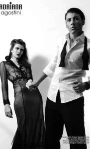 Black-and-white campaign portrait of a woman in a sculptural gown beside a tailored model
